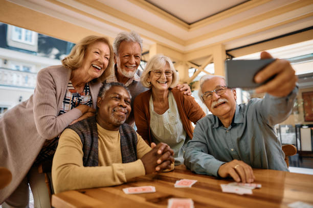 Group of residents laughing together over a card game